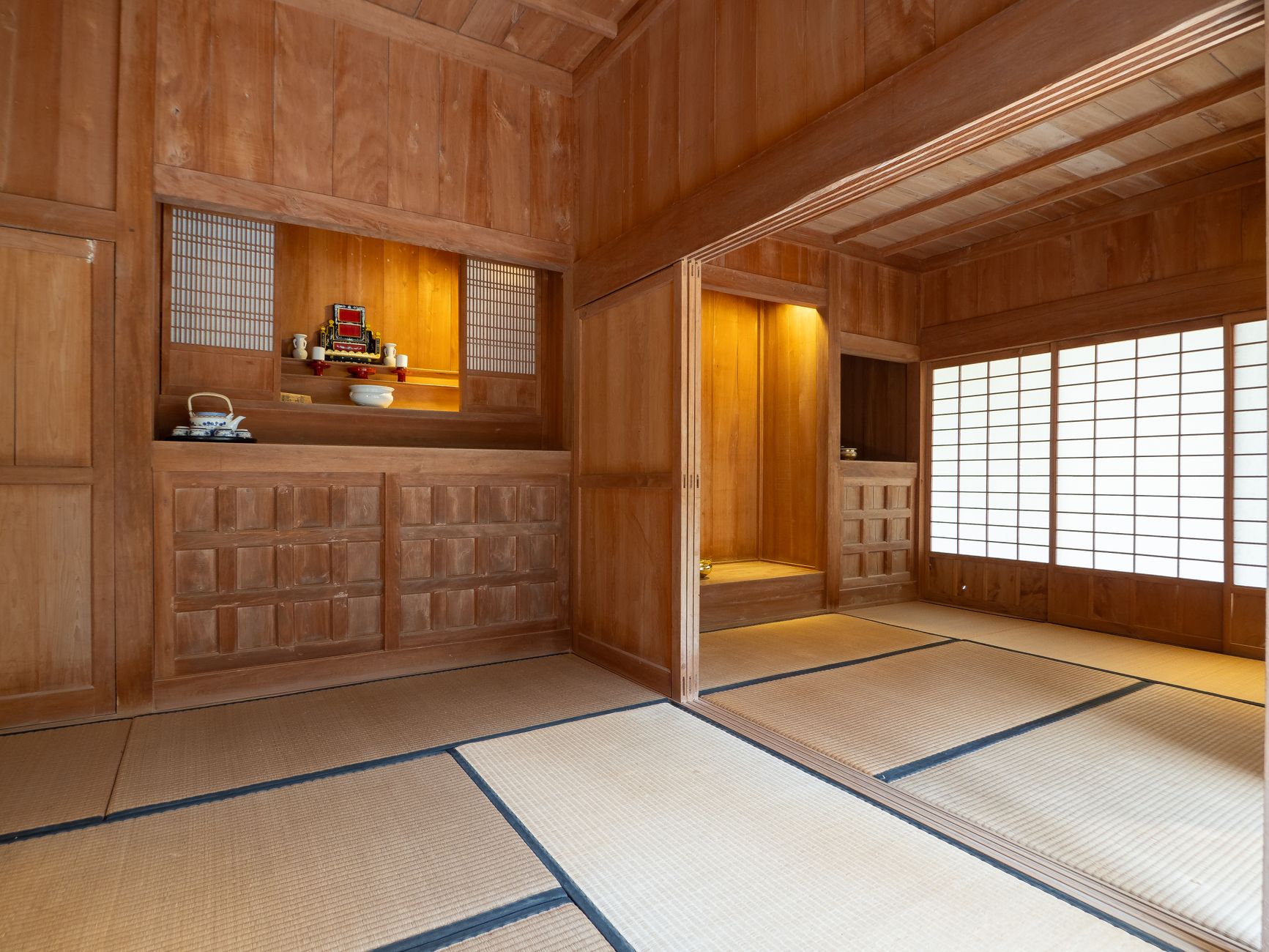 Traditional Japanese tea ceremony sunken hearth with glowing charcoal, iron kettle suspended above, surrounded by tatami mats in winter tearoom.