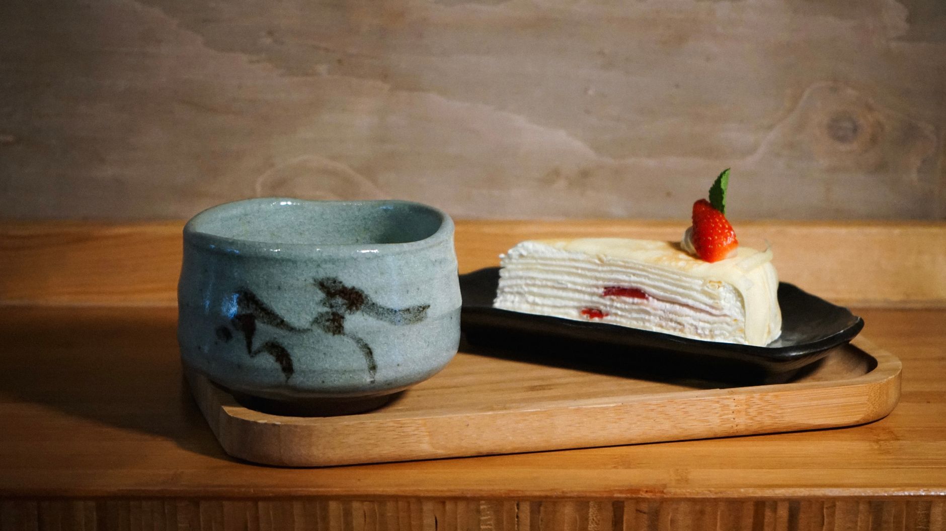 White and blue porcelain bowls and plates with minimalist designs stacked together, showcasing traditional Hasami ware pottery from Nagasaki, Japan.