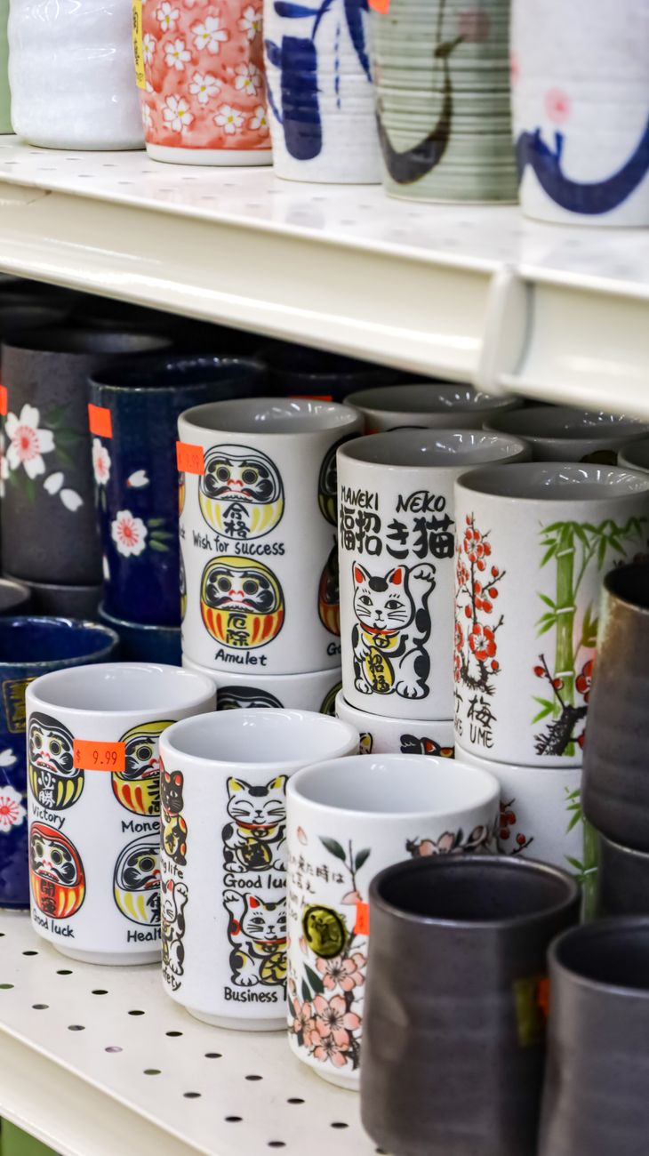 White and blue porcelain bowls and plates with minimalist designs stacked together, showcasing traditional Hasami ware pottery from Nagasaki, Japan.