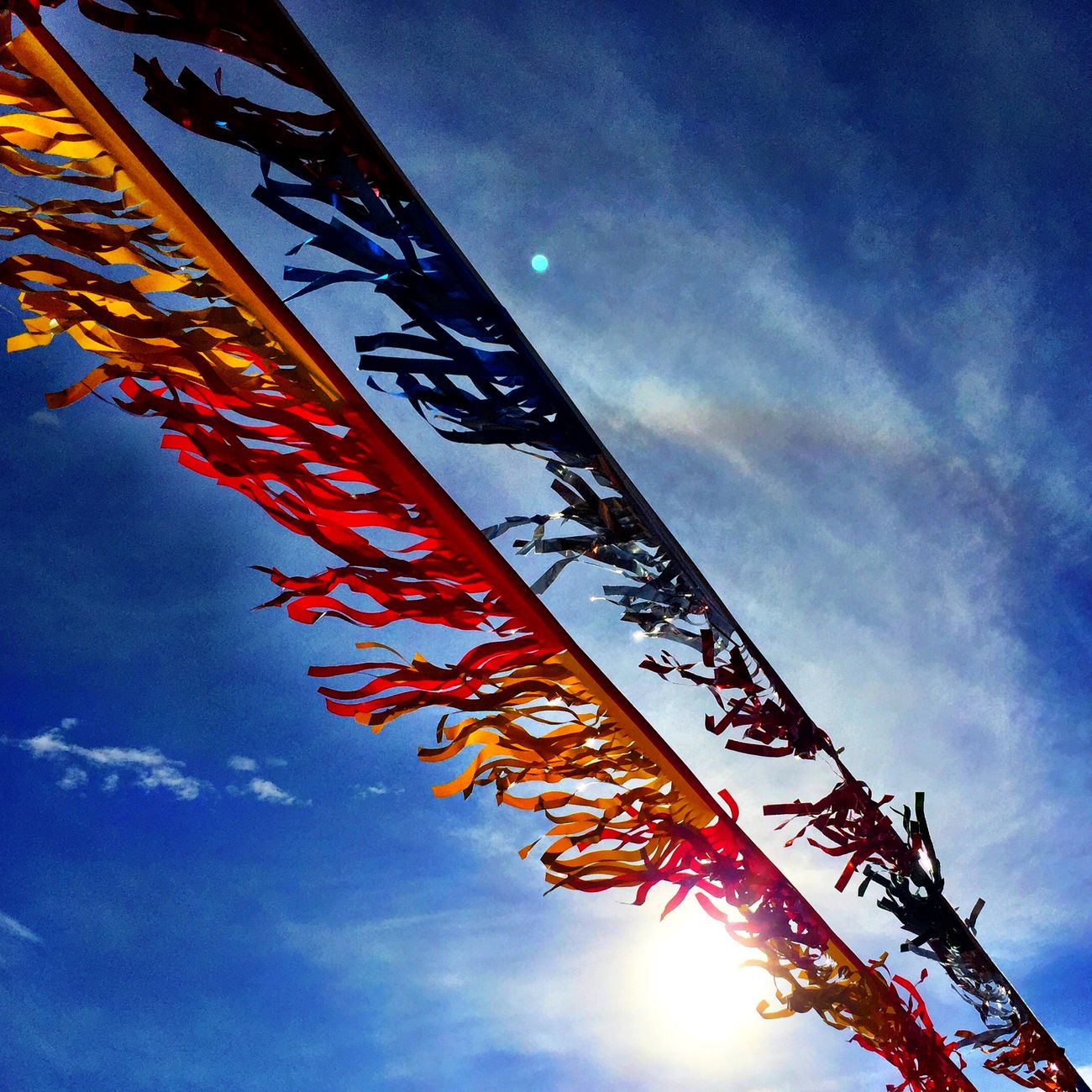 Colorful paper strips and origami decorations hanging from bamboo branches during Japan's summer Tanabata Star Festival celebration.