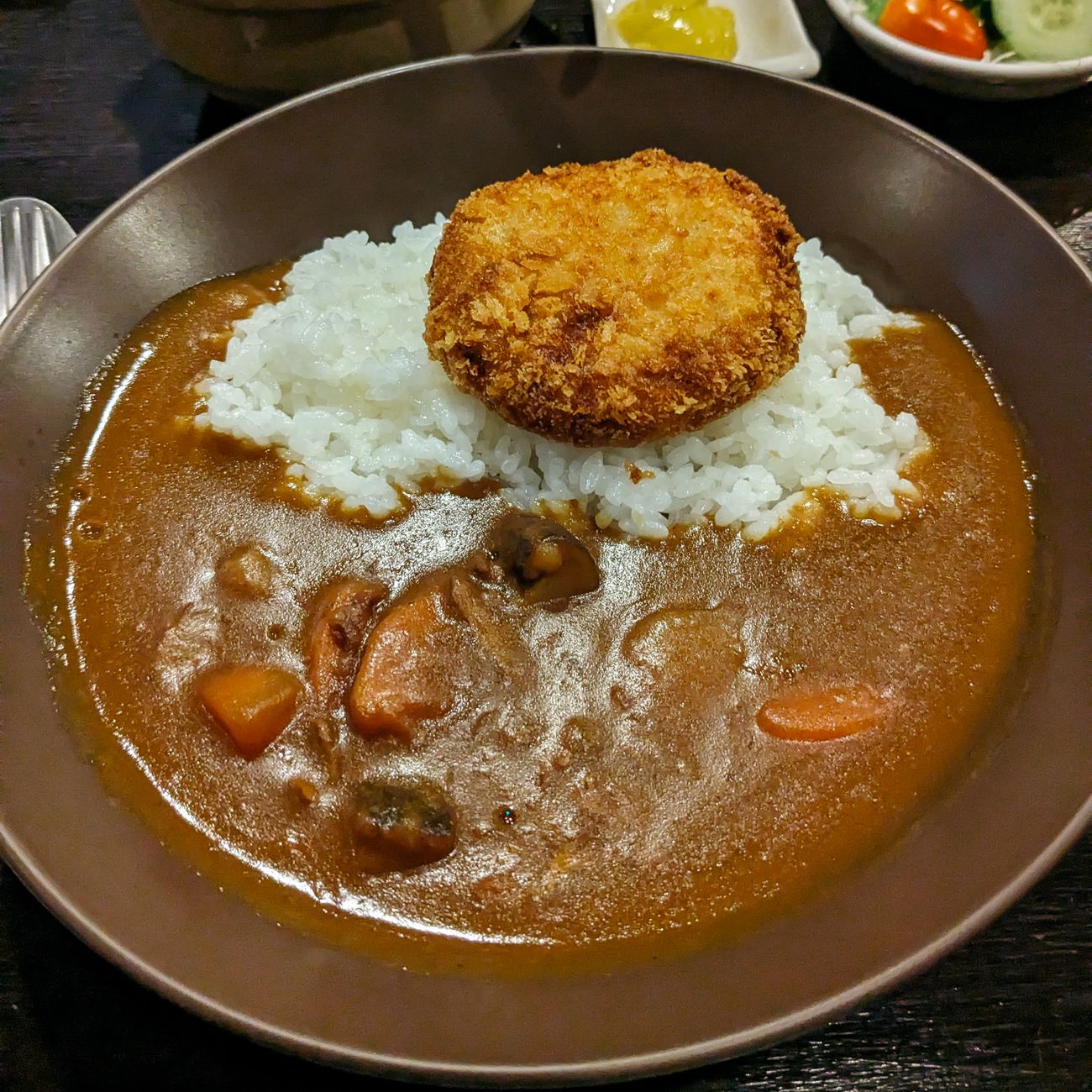 Traditional Japanese washoku meal arranged on lacquerware featuring seasonal ingredients, rice, miso soup, and pickled vegetables in harmonious presentation.