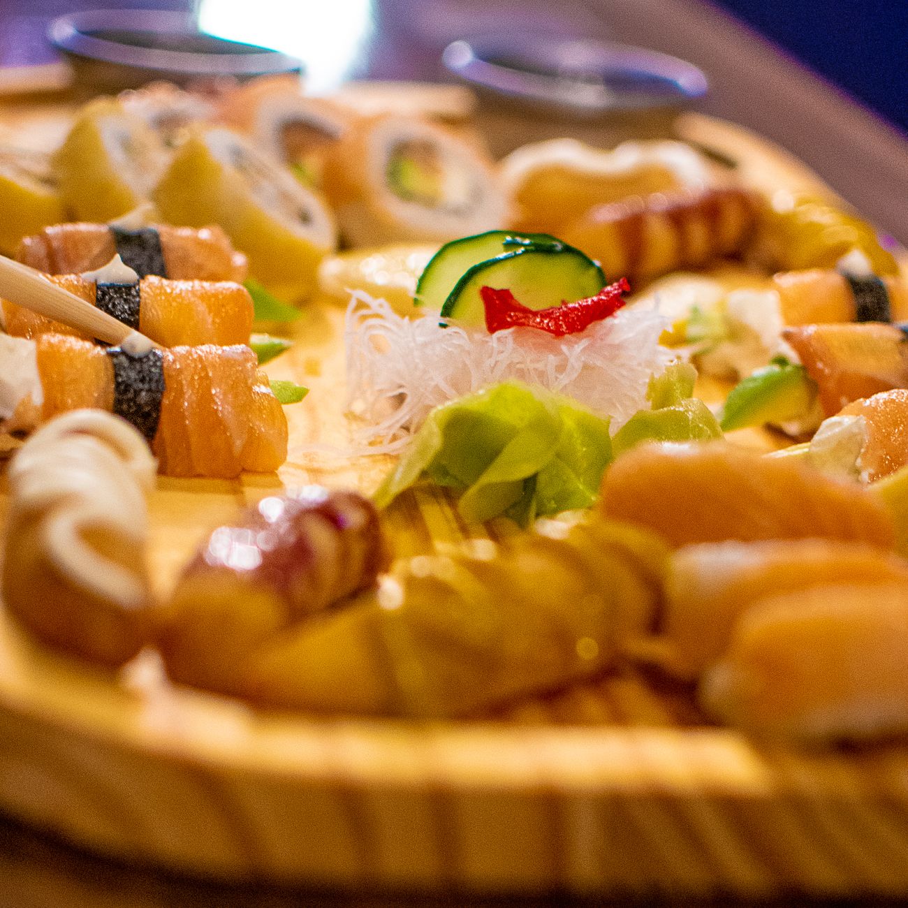 Glossy white sushi rice seasoned with rice vinegar, shaped into small oval mounds on a wooden cutting board.