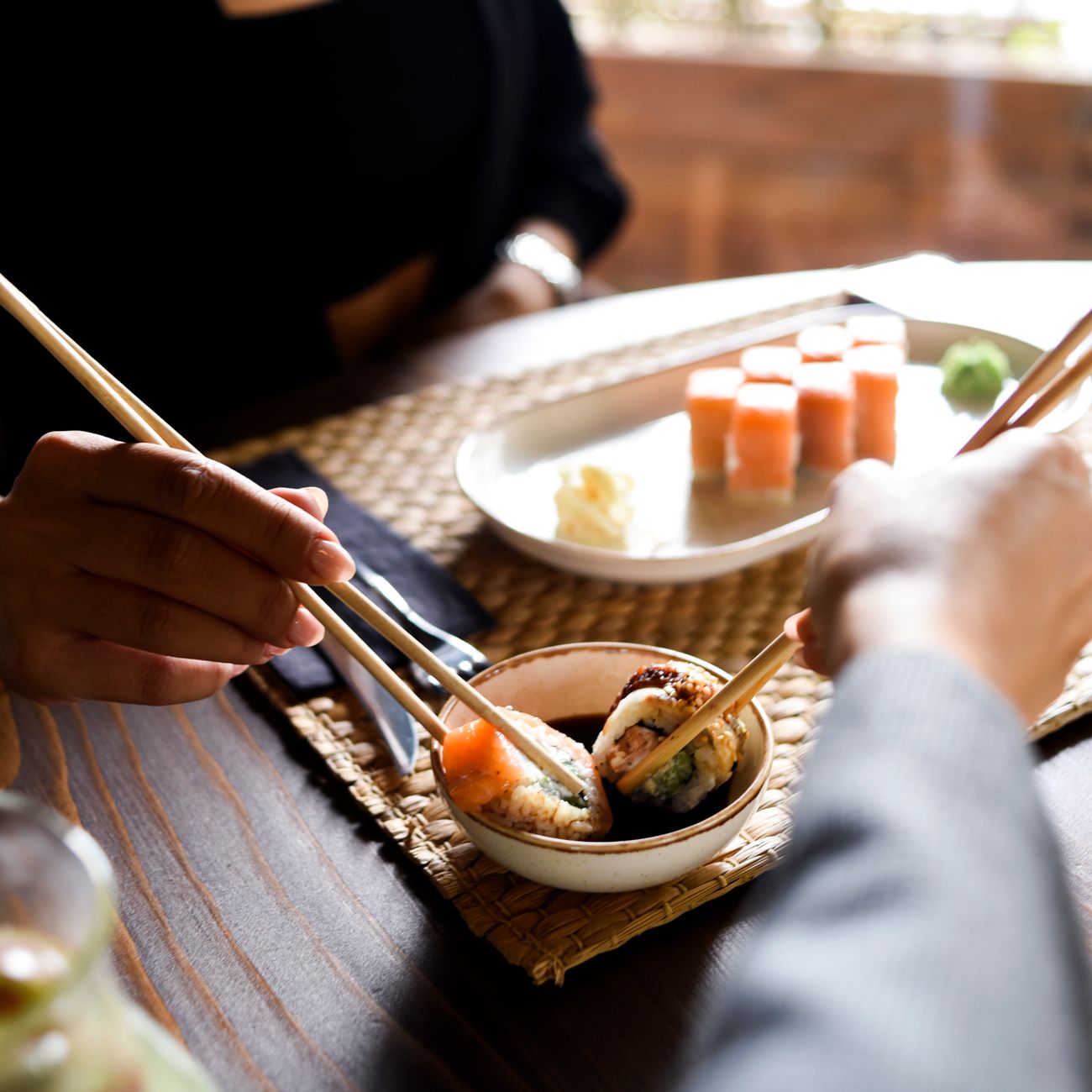 Chopsticks standing upright in a bowl of white rice, demonstrating the Japanese funeral ritual taboo.