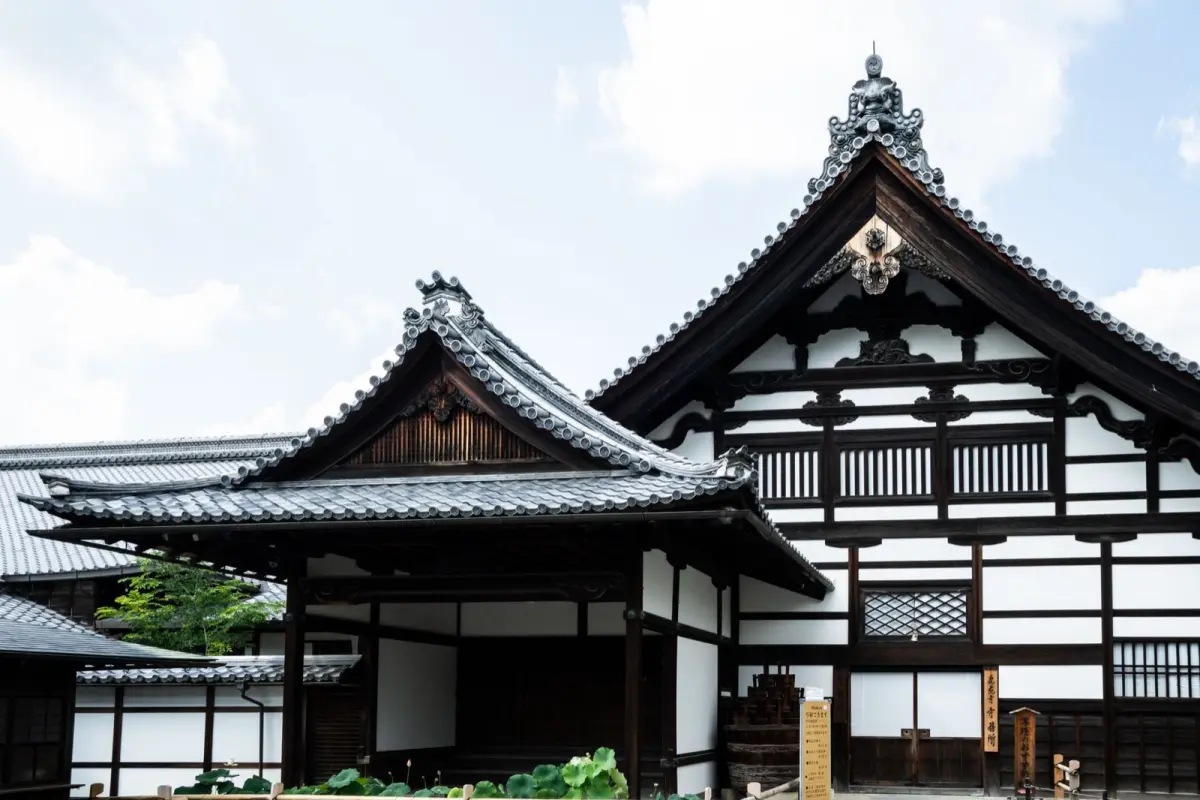 Stone garden with raked gravel patterns and moss-covered rocks at a traditional Japanese Zen temple in Kyoto.