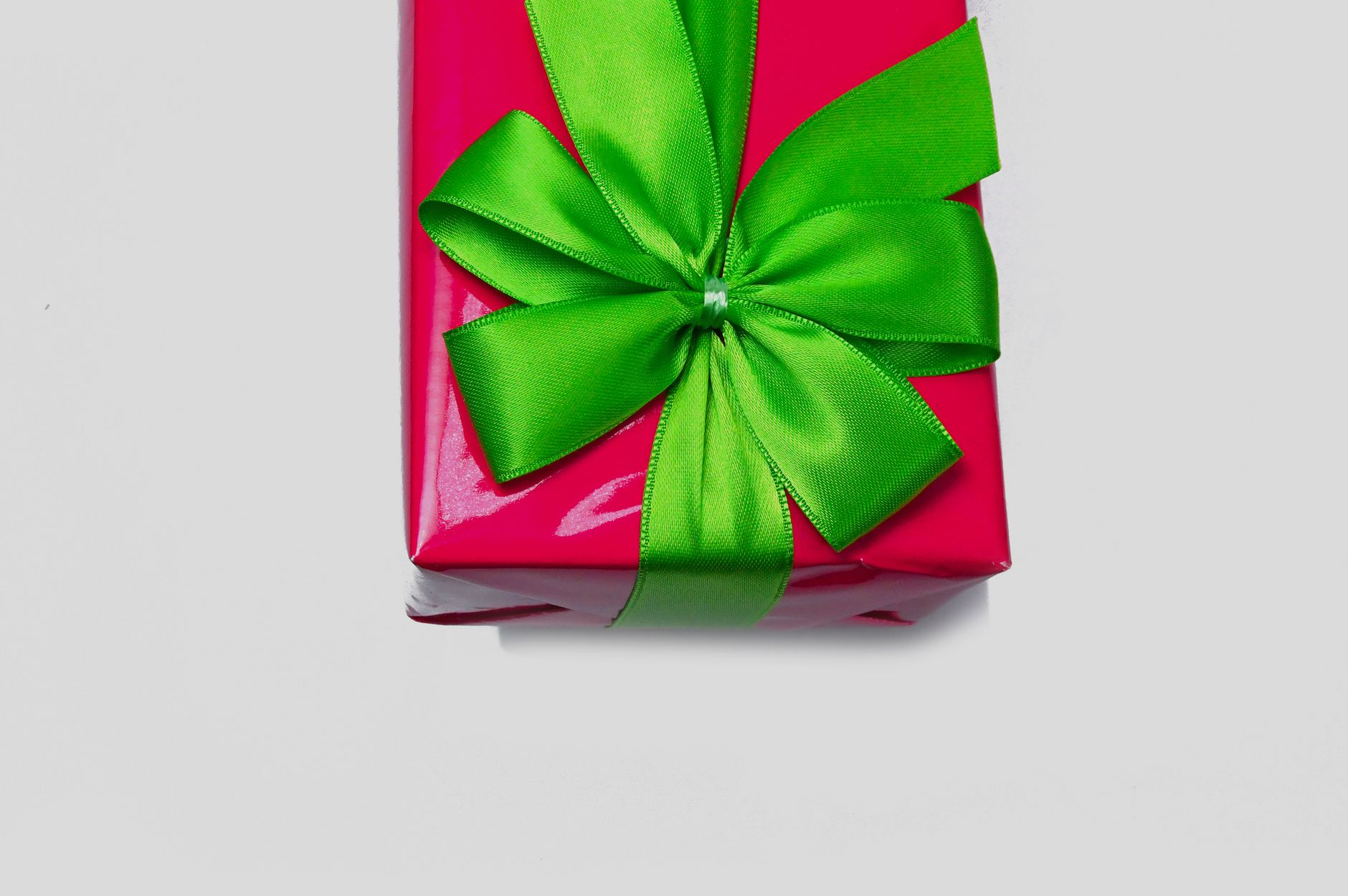 Wrapped gift boxes with traditional mizuhiki cord decorations arranged on a wooden table for Japanese seasonal gift-giving ceremony.