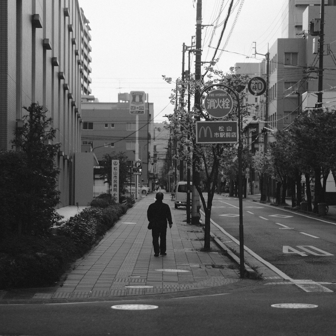 Japanese businesspeople in a modern office observing subtle social cues during a quiet meeting with minimal verbal communication.