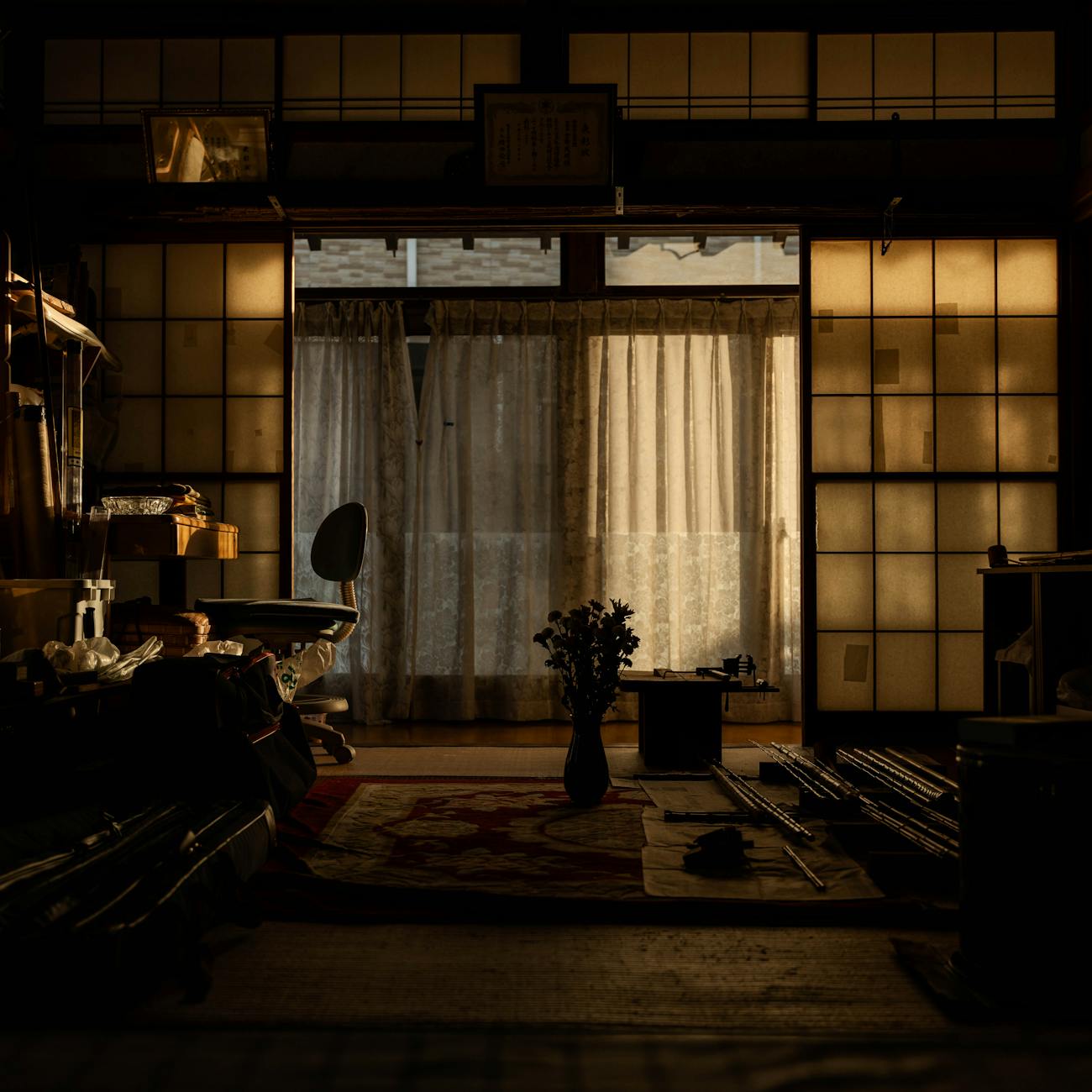 Neatly arranged shoes and slippers at a traditional Japanese home entrance with wooden flooring and sliding doors.
