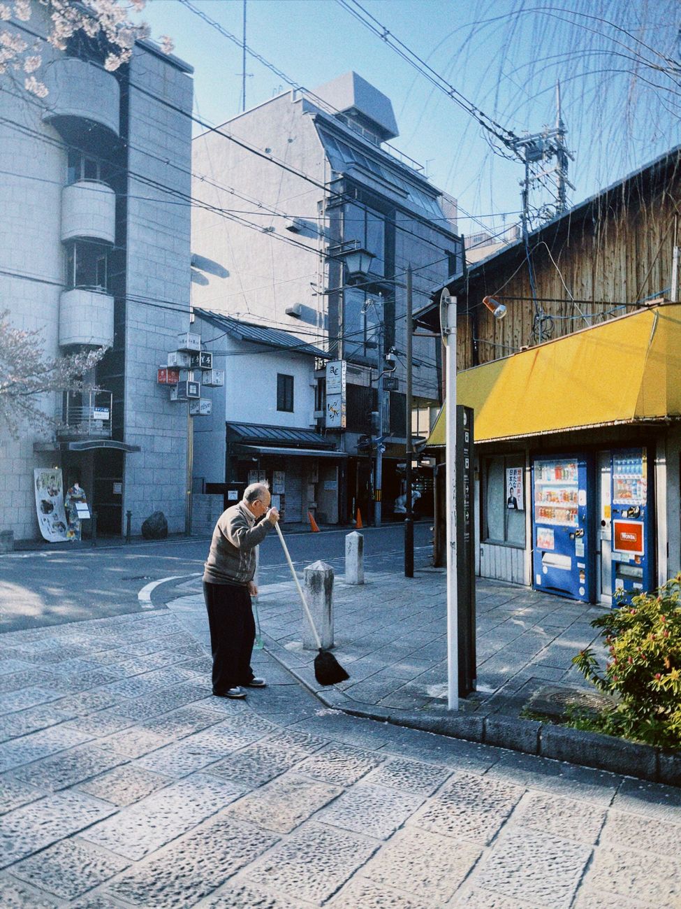 Neatly arranged shoes and slippers at a traditional Japanese home entrance with wooden flooring and sliding doors.