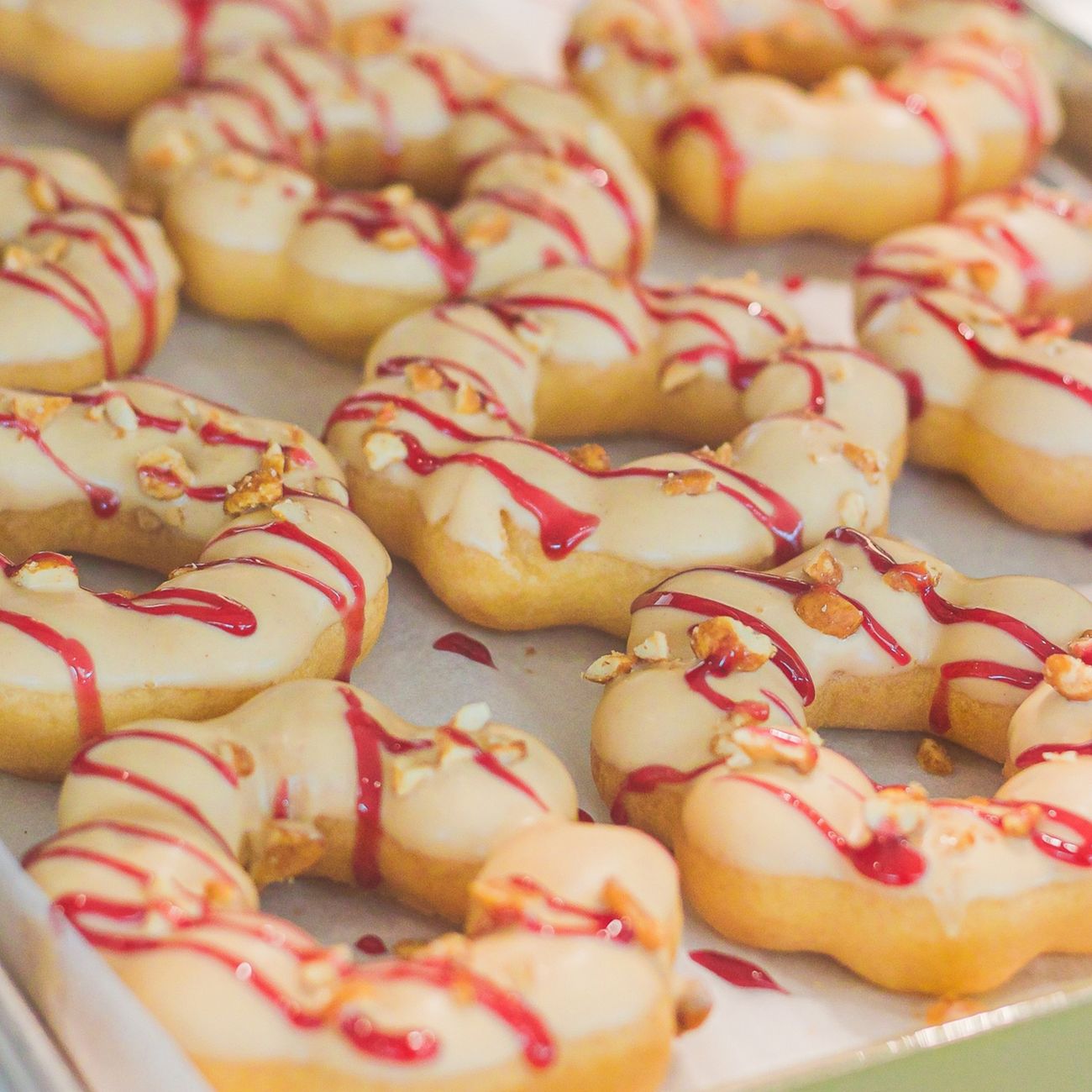 Round white mochi rice cakes stacked on red lacquer plates with pine decorations for Japanese New Year celebration.