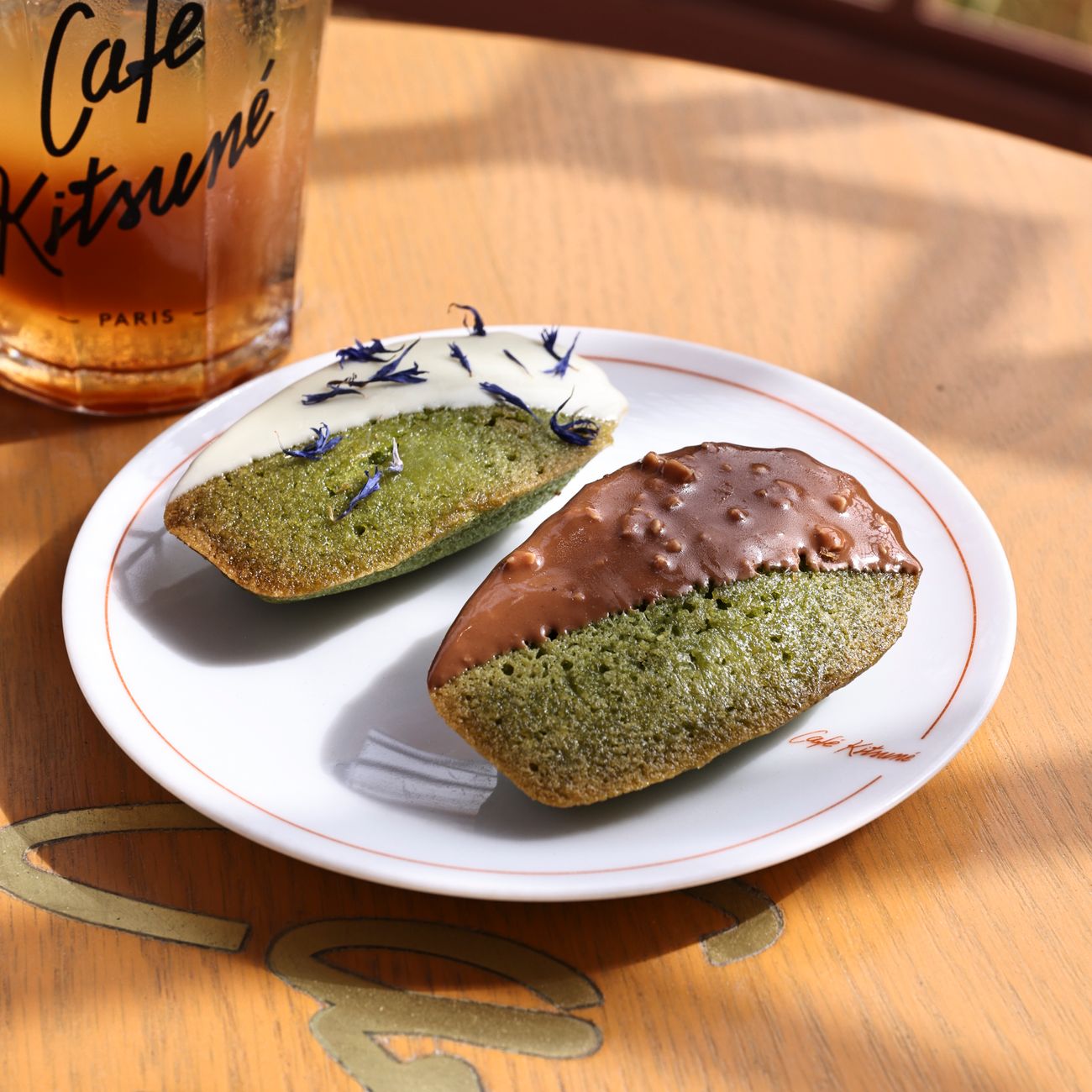 Vibrant green matcha powder whisked into foam inside a traditional ceramic tea bowl with bamboo chasen whisk nearby.
