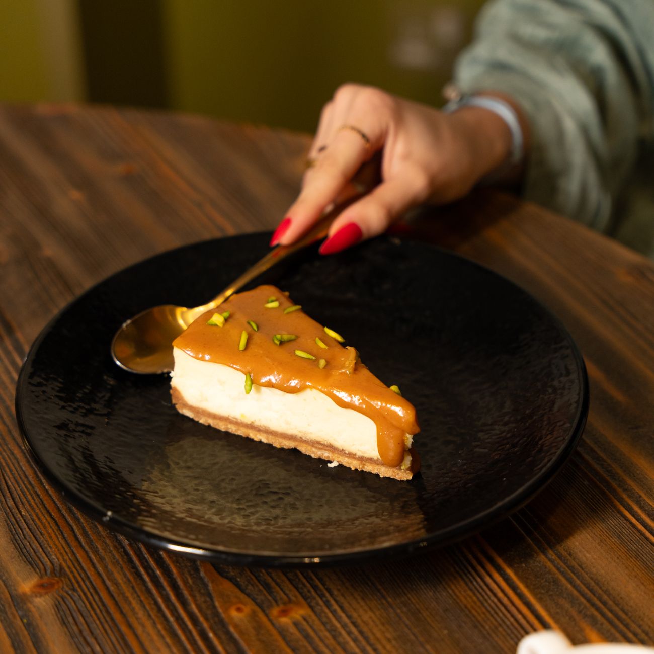 Traditional bamboo chasen whisk creating delicate foam on vibrant green matcha tea in a ceramic bowl