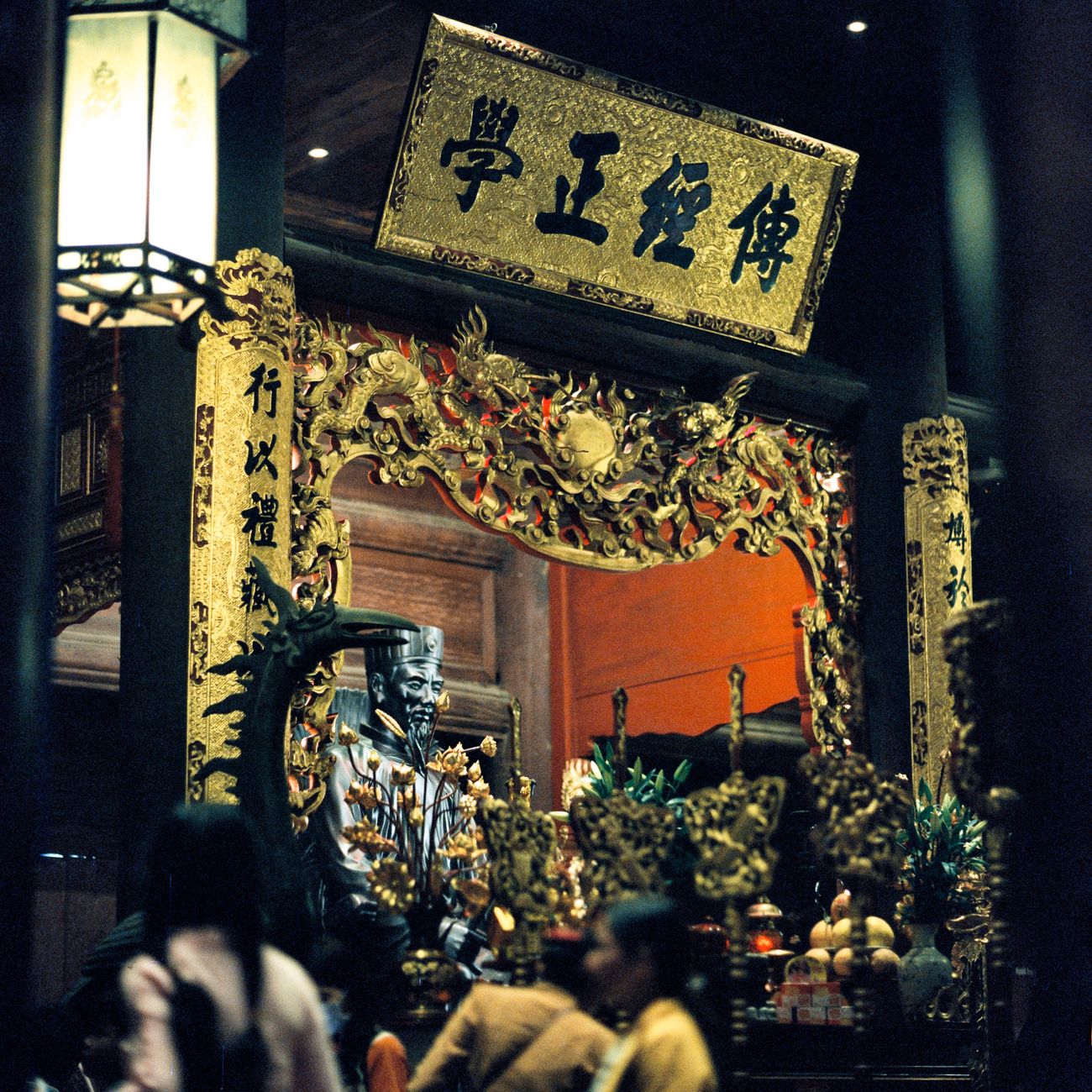 Traditional wooden temple roofs and pagoda rising above Kyoto's historic cityscape with mountains visible in the background.