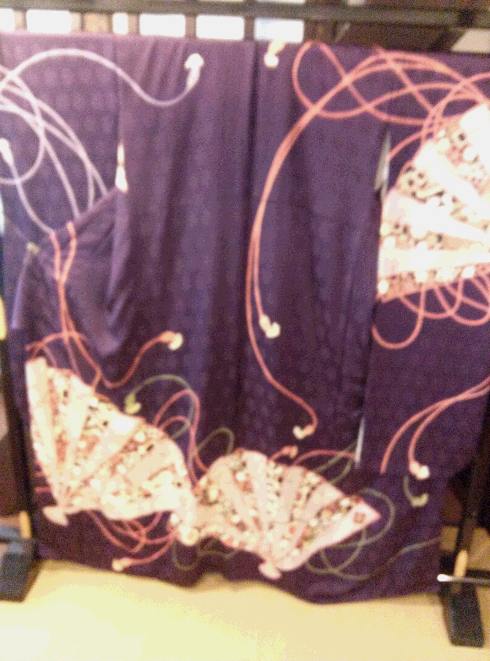 Traditional Nishijin织机 loom with colorful silk threads being woven into intricate brocade patterns in a Kyoto workshop.
