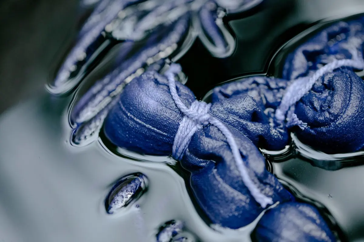 Indigo-dyed fabric hanging to dry in Tokushima, showing deep blue gradients from traditional awa ai fermentation dyeing.