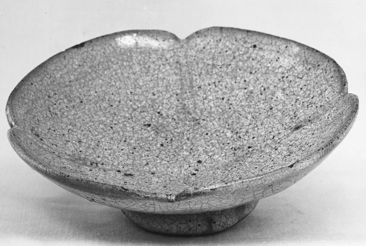 Pale cream Hagi ware tea bowl with rough texture showing subtle pink and beige color changes from tea staining over time.
