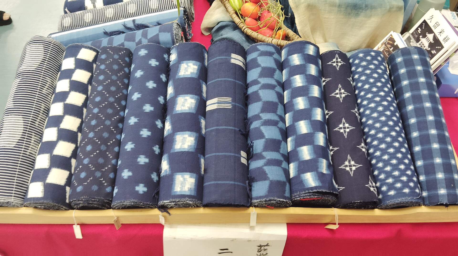 Traditional Japanese indigo kasuri fabric showing white geometric ikat patterns against deep blue cotton, displaying the distinctive Kurume weaving technique.