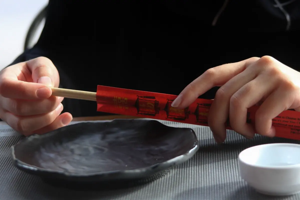 Close-up of Tsugaru nuri lacquerware showing distinctive speckled multicolored surface pattern created through traditional Aomori polishing techniques.