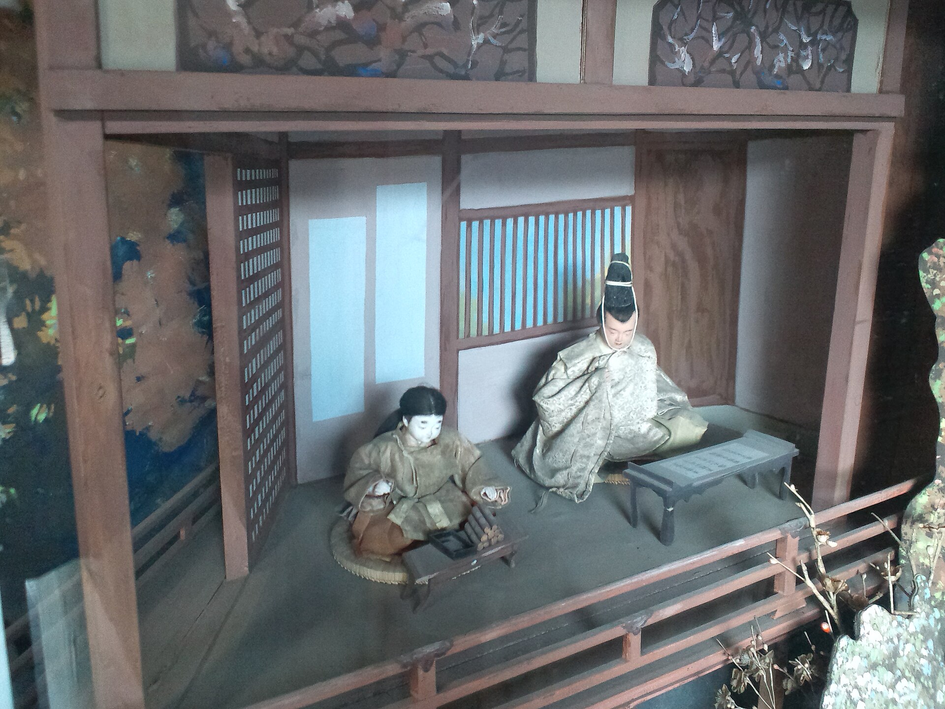 Traditional Hakata clay doll featuring a geisha in kimono with delicate hand-painted facial features and vibrant colors.