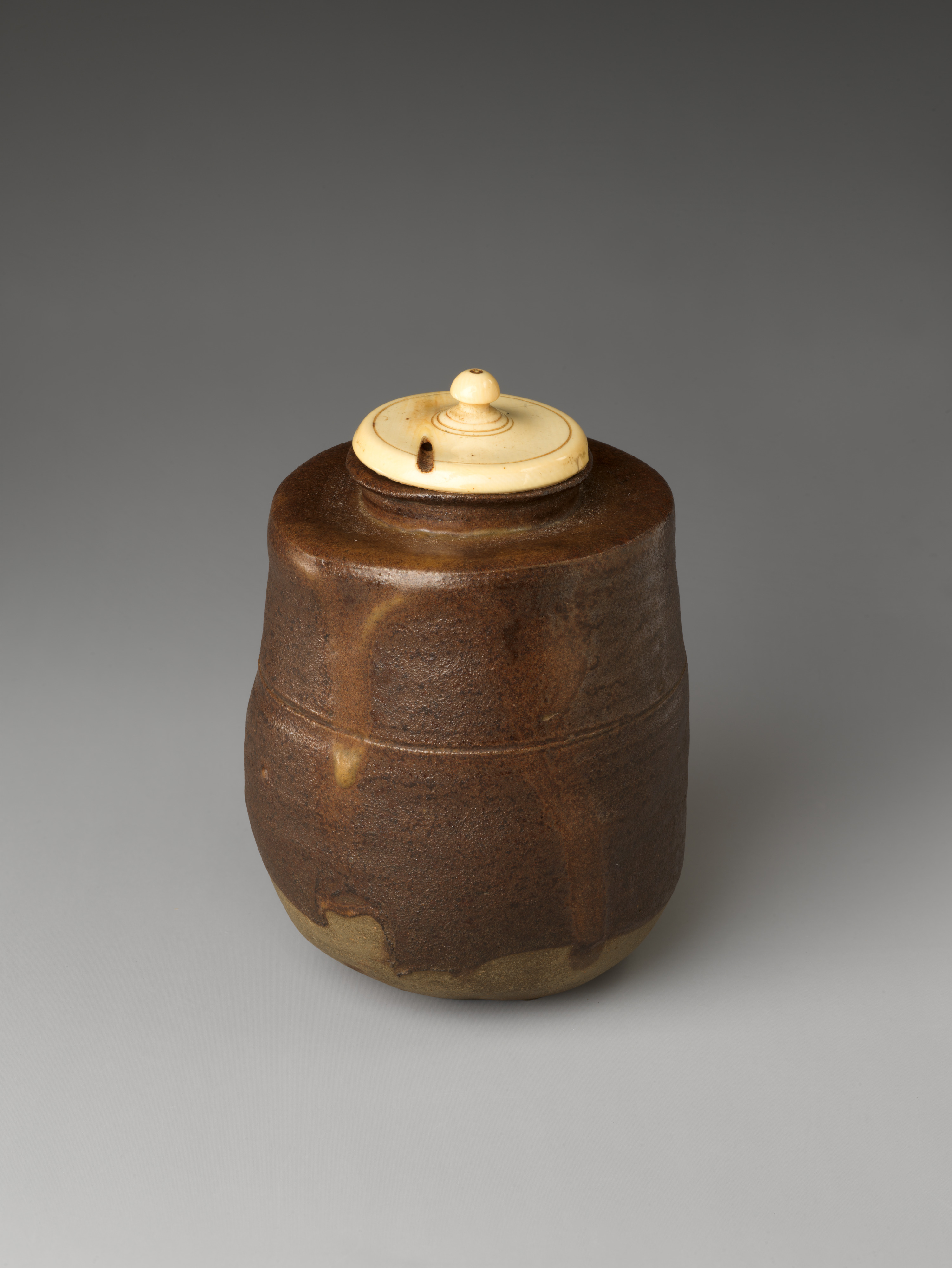 Traditional Japanese tea ceremony room with tatami mats, bamboo whisk, and ceramic bowl arranged in formal preparation style.