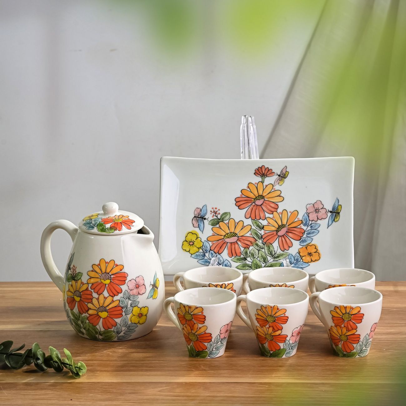 White and blue Arita porcelain bowls and plates arranged on a traditional Japanese dining table with chopsticks and tea cups.